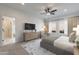 Serene main bedroom with neutral tones, ample natural light, and desert views from the windows at 10907 W Woodruff Rd, Casa Grande, AZ 85194