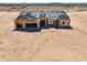 New home under construction with a two-car garage and desert landscape at 10947 W Woodruff Rd, Casa Grande, AZ 85194