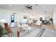 Inviting living room featuring wood-look floors, contemporary furniture, and an open layout flowing into the kitchen at 10947 W Woodruff Rd, Casa Grande, AZ 85194