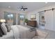 Serene main bedroom with desert views, a ceiling fan, and an en-suite bathroom featuring a sliding barn door at 10947 W Woodruff Rd, Casa Grande, AZ 85194