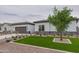 Inviting single-story home with well-manicured front yard and desert landscaping elements at 10981 W Woodruff Rd, Casa Grande, AZ 85194