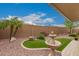 Charming backyard featuring well-maintained landscaping, a decorative fountain, and a seating area at 11055 E Ocaso Ave, Mesa, AZ 85212