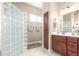 Stylish bathroom featuring a glass block shower, wood cabinetry, and neutral colors at 11055 E Ocaso Ave, Mesa, AZ 85212