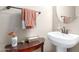 Charming powder room featuring a pedestal sink, decorative accents, and soft lighting at 11055 E Ocaso Ave, Mesa, AZ 85212