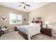 Cozy bedroom featuring neutral walls, ceiling fan, plantation shutters, and comfortable decor at 11055 E Ocaso Ave, Mesa, AZ 85212