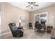 Bedroom with a ceiling fan, large window, and a functional setup for work or relaxation at 11055 E Ocaso Ave, Mesa, AZ 85212