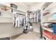 Bright walk-in closet with abundant shelving and hanging space for optimal organization and storage at 11055 E Ocaso Ave, Mesa, AZ 85212