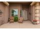 Covered entryway featuring a decorative front door, seating, and stylish accents at 11055 E Ocaso Ave, Mesa, AZ 85212