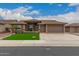 Charming home featuring manicured landscaping, a three-car garage, and a welcoming entryway at 11055 E Ocaso Ave, Mesa, AZ 85212