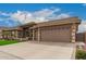 Charming home featuring manicured landscaping, a three-car garage, and a welcoming entryway at 11055 E Ocaso Ave, Mesa, AZ 85212