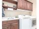 Convenient laundry room with updated cabinets, ample counter space, and a modern washer and dryer at 11055 E Ocaso Ave, Mesa, AZ 85212