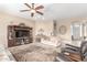 Inviting living room featuring a ceiling fan, entertainment center, and comfortable seating arrangements at 11055 E Ocaso Ave, Mesa, AZ 85212