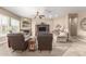 Comfortable living room featuring a fireplace, entertainment center, and neutral decor at 11055 E Ocaso Ave, Mesa, AZ 85212