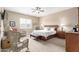 Serene main bedroom with a ceiling fan, a queen bed, and a sitting area near the windows at 11055 E Ocaso Ave, Mesa, AZ 85212