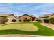 Backyard featuring a well-maintained putting green, desert landscaping, and mature shrubbery at 11277 W Buchanan St, Avondale, AZ 85323