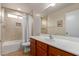 Bright bathroom features a tiled shower-tub combo and a vanity with ample counter space at 11277 W Buchanan St, Avondale, AZ 85323