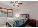 A cozy bedroom includes a comfortable bed, ceiling fan, and a window that provides natural light at 11277 W Buchanan St, Avondale, AZ 85323