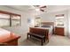 This bedroom has a wood bed, ceiling fan, and two windows providing natural light and views at 11277 W Buchanan St, Avondale, AZ 85323