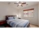 The bedroom offers a comfortable bed, ceiling fan, and a window overlooking the outdoors at 11277 W Buchanan St, Avondale, AZ 85323