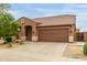Attractive single-story house with a large driveway and classic tile roof at 11277 W Buchanan St, Avondale, AZ 85323