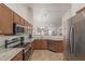 An updated kitchen features stainless steel appliances, granite countertops, and a functional open layout at 11277 W Buchanan St, Avondale, AZ 85323