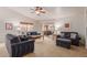 Comfortable living room featuring plush furniture, a ceiling fan, and sliding glass doors at 11277 W Buchanan St, Avondale, AZ 85323