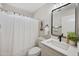 Charming bathroom features stylish mirror, sink, vanity, and shower with curtain at 116 W Jasper Dr, Gilbert, AZ 85233