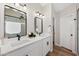 Bathroom with double vanity, white counters, and modern fixtures under elegant lighting at 116 W Jasper Dr, Gilbert, AZ 85233