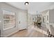 Bright entryway with wood flooring and ample natural light flowing into the adjacent dining area and providing a welcoming feel at 116 W Jasper Dr, Gilbert, AZ 85233
