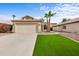 Charming single-story home with lush green lawn and desert landscaping with a two car garage and neutral color palette at 116 W Jasper Dr, Gilbert, AZ 85233