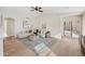 Cozy living room with vaulted ceilings, neutral decor, wood flooring, and sliding doors leading to the outdoor space at 116 W Jasper Dr, Gilbert, AZ 85233