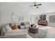 Bright living room with neutral furniture, vaulted ceiling, wood floors, and stylish decor, making it perfect for relaxation at 116 W Jasper Dr, Gilbert, AZ 85233