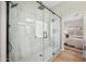 Luxurious shower boasts marble-style walls, rainfall showerhead, and glass door at 116 W Jasper Dr, Gilbert, AZ 85233