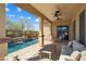 Inviting outdoor space includes a private pool and covered patio with comfortable seating at 12047 W Red Hawk Dr, Peoria, AZ 85383