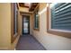 The entryway features a beautiful stone floor and iron work front door for an elegant entrance at 12047 W Red Hawk Dr, Peoria, AZ 85383