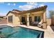 Beautiful exterior view of the covered patio with pool, and adjacent home at 12047 W Red Hawk Dr, Peoria, AZ 85383