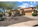 Charming single-Gathering home with stone accents, desert landscaping, and a paved driveway at 12047 W Red Hawk Dr, Peoria, AZ 85383