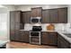 Detailed kitchen showcasing wood cabinets, granite countertops, and stainless steel appliances at 12047 W Red Hawk Dr, Peoria, AZ 85383