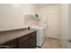 Well-lit laundry room with washer, dryer, storage, and ample counter space at 12047 W Red Hawk Dr, Peoria, AZ 85383