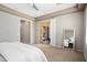 Bedroom with sliding glass doors to outdoor area and mirror on the wall at 12047 W Red Hawk Dr, Peoria, AZ 85383