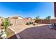 Spacious backyard featuring desert landscaping and a cozy seating area with a fire pit, perfect for relaxing outdoors at 12415 N 41St Dr, Phoenix, AZ 85029