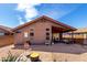 The backyard has a cozy covered patio and desert landscaping, perfect for easy maintenance and enjoying the outdoors at 12415 N 41St Dr, Phoenix, AZ 85029