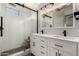 Bright bathroom features a dual sink vanity, an updated shower, and modern fixtures at 12415 N 41St Dr, Phoenix, AZ 85029