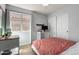Cozy bedroom with a large window, wood-look floors, closet and modern decor accents at 12415 N 41St Dr, Phoenix, AZ 85029