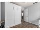 Clean bedroom featuring a Murphy bed, white trim, wood look flooring, and neutral paint at 12415 N 41St Dr, Phoenix, AZ 85029