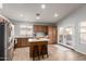 Spacious kitchen featuring stainless steel appliances, a breakfast bar, and modern cabinetry at 12415 N 41St Dr, Phoenix, AZ 85029