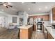 Bright kitchen boasts stainless steel appliances, an island, and wood-look tile flooring at 12415 N 41St Dr, Phoenix, AZ 85029