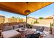 Inviting covered patio featuring comfortable seating, wooden ceiling, and a well-maintained yard at 12415 N 41St Dr, Phoenix, AZ 85029