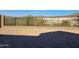 View of the backyard featuring an iron fence with a block wall and desert landscape beyond at 13250 W Eagle Feather Rd, Peoria, AZ 85383