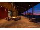 Community firepit area with comfortable seating, overhead lighting, and mountain views at sunset at 13250 W Eagle Feather Rd, Peoria, AZ 85383